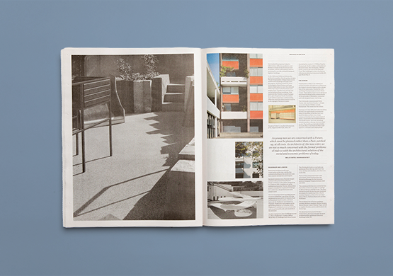 Open tabloid featuring modernist architecture shown on a blue background